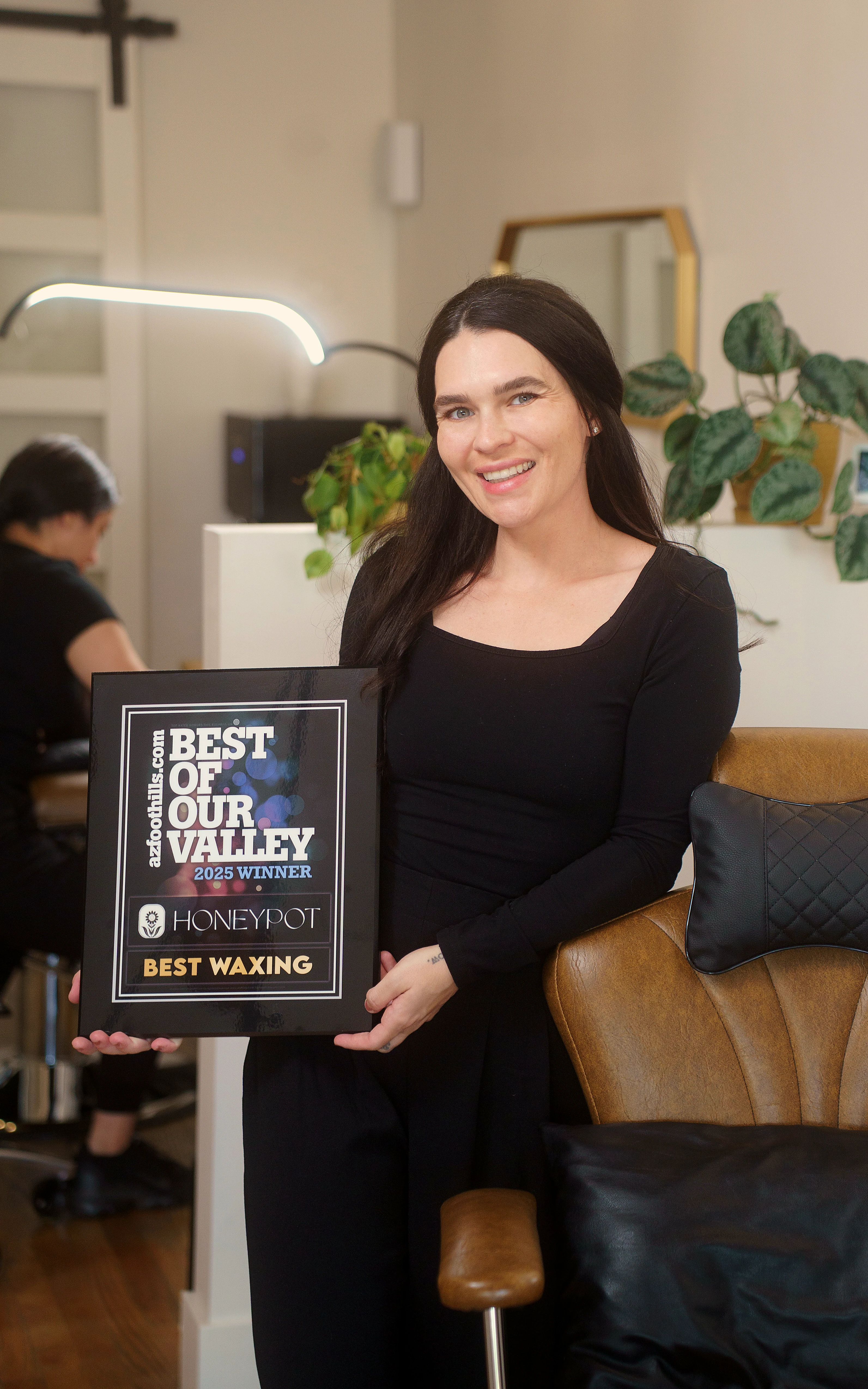 Dani Horwitz holding the Best of Our Valley 2025 award for Best Waxing